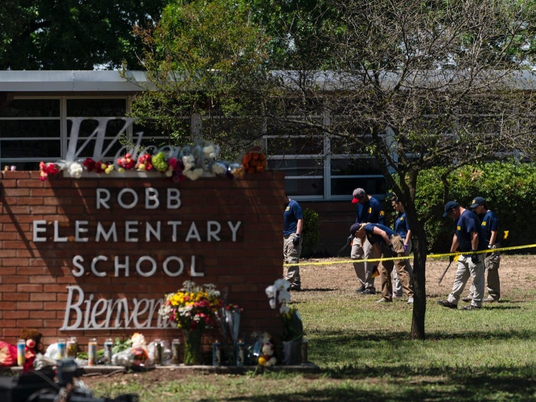 Investigators search for evidences outside Robb Elementary School in Uvalde, Texas, Wednesday, May 25, 2022. 