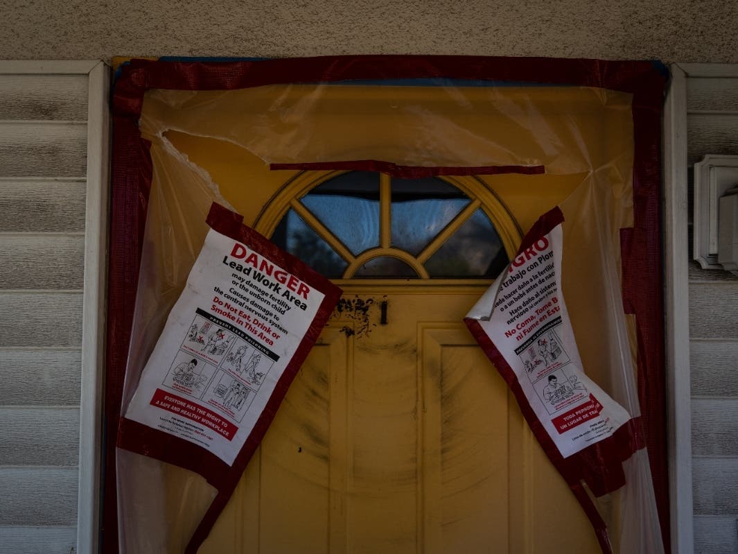 Los Angeles Wildfires ContaminationWarning notices are posted on the door of a home that survived the Eaton Fire, Dec. 3, 2025, in Altadena, Calif.