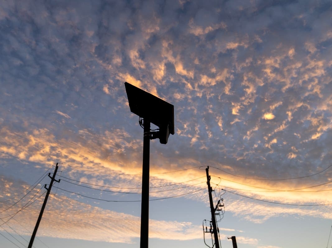 A Flock Safety license plate reader is seen along a public road.