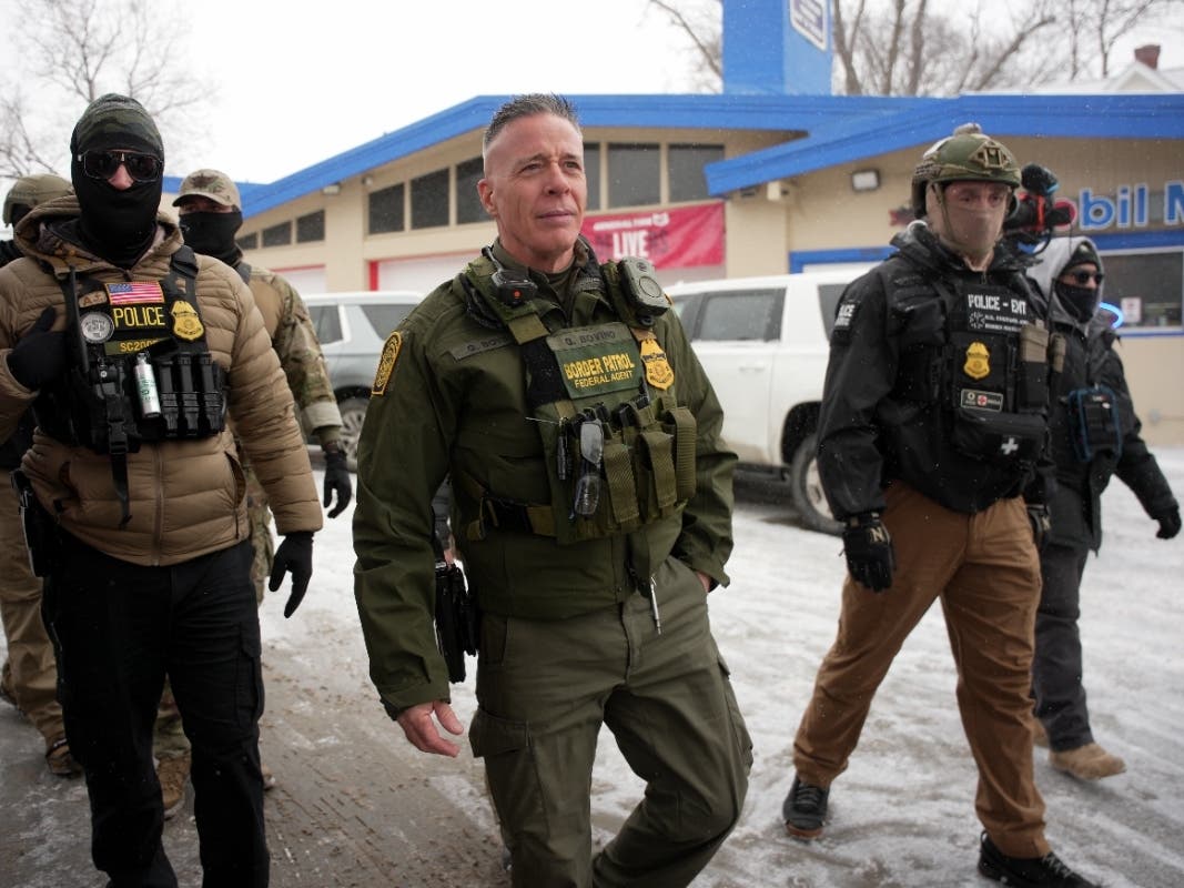 U.S. Border Patrol Cmdr. Gregory Bovino walks with Federal agents outside a convenience store on Wednesday, Jan. 21, 2026, in Minneapolis. 