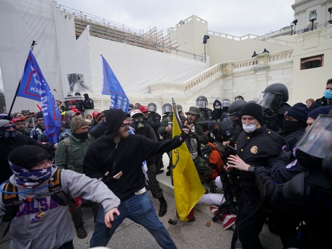 Trump supporters try to break through a police barrier Wednesday at the Capitol. As Congress prepared to affirm President-elect Joe Biden's victory, thousands of people gathered to support President Donald Trump and his claims of election fraud.