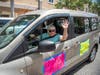 Heather Lawler waves to onlookers during Saturday's protest of Manatee County Commissioner Vanessa Baugh for her role in an exclusive vaccine clinic in Lakewood Ranch.