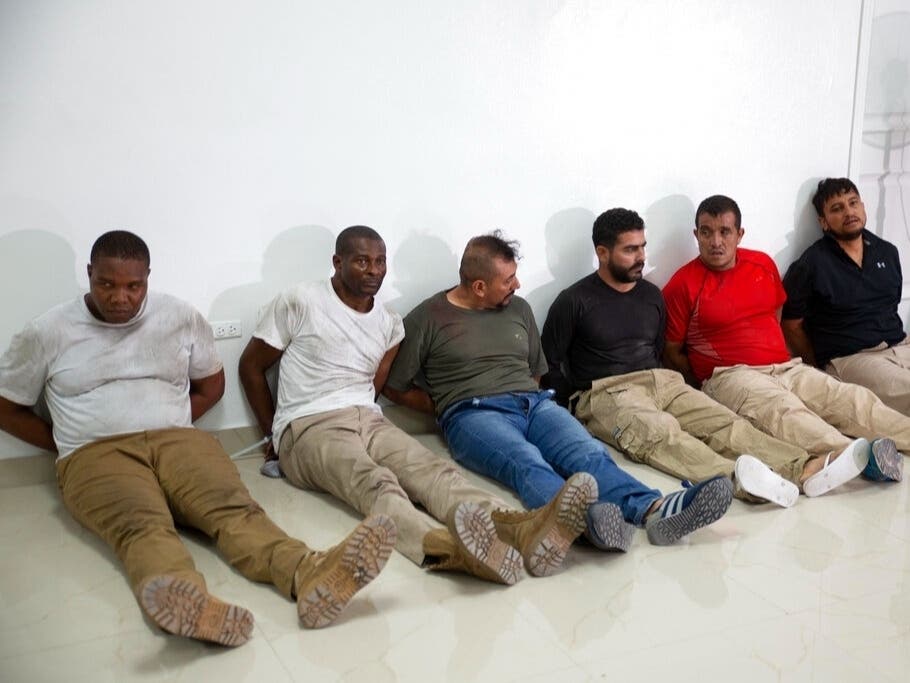 Suspects in the assassination of Haiti's President Jovenel Moïse, among them Haitian-American citizens James Solages, left, and Joseph Vincent, second left, are shown to the media by police in Port-au-Prince, Haiti, Thursday.