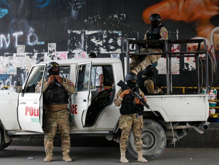 Police stand guard under an overpass in Port-au-Prince, Haiti Monday. President Jovenel Moïse was assassinated Wednesday. A South Florida doctor was detained and accused of being a leader of the assassination plot.