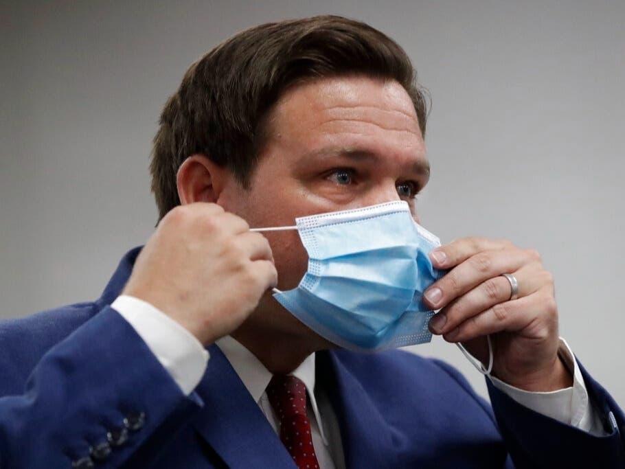 One beer koozie sold by the fundraising group for Florida's Republican Gov. Ron DeSantis reads, “How the hell am I going to be able to drink a beer with a mask on?”