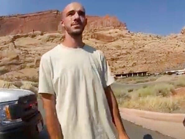 Brian Laundrie speaks with an officer after police pulled over the van he was traveling in with his fiancée, Gabby Petito, Aug. 12. He’s been missing since Sept. 14 and is a person of interest in her death. His sister urges him to "come forward."