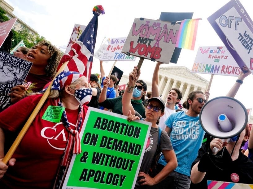 Pro-abortion protesters gather outside the Supreme Court in Washington. The court ended constitutional protections for abortion that had been in place 50 years — a decision by its conservative majority to overturn the court's landmark abortion cases.