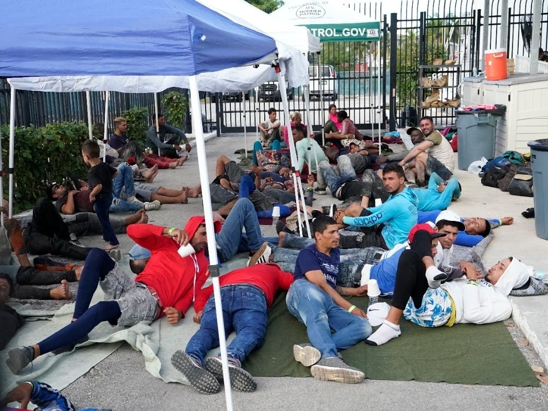 ​​​​Recently arrived migrants wait in a garage area of the U.S. Customs and Border Protection's Marathon Border Patrol Station on Wednesday. More than 500 Cuban immigrants have come ashore in the Florida Keys since New Year's Eve weekend.
