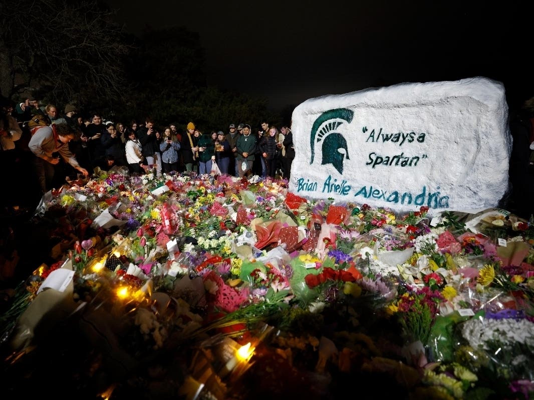 Flowers seen at the base of The Rock at Michigan State University in East Lansing honor the victims of Monday's shooting on campus. One of the victims was a Southwest Florida student, Guadalupe Huapilla-Perez, a junior hospitality business major at MSU.