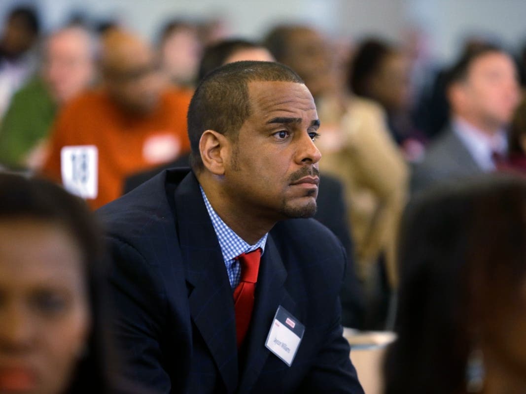 Former NBA basketball player Jayson Williams listens as he sits in the audience during a prisoner re-entry conference in Jersey City, N.J., Thursday, April 17, 2014.
