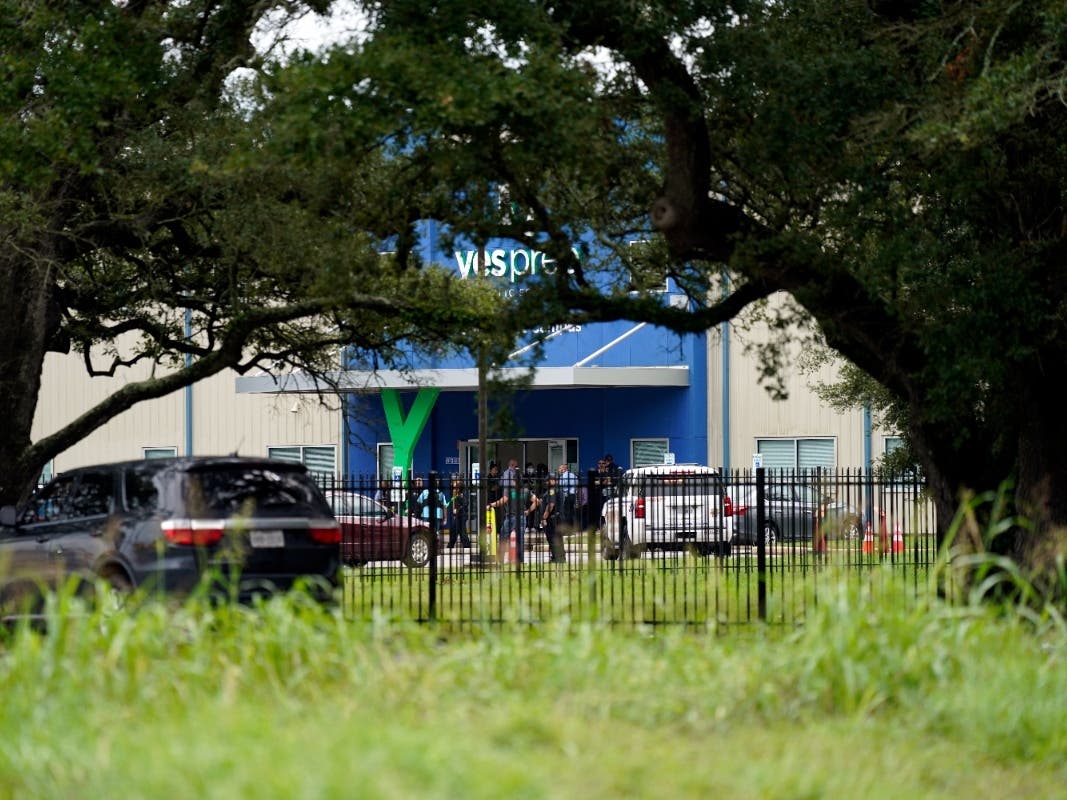 Law enforcement officers gather outside YES Prep Southwest Secondary school after a shooting on Friday in Houston. Principal Eric Espinoza was shot and wounded by a former student. He has since been released from the hospital.
