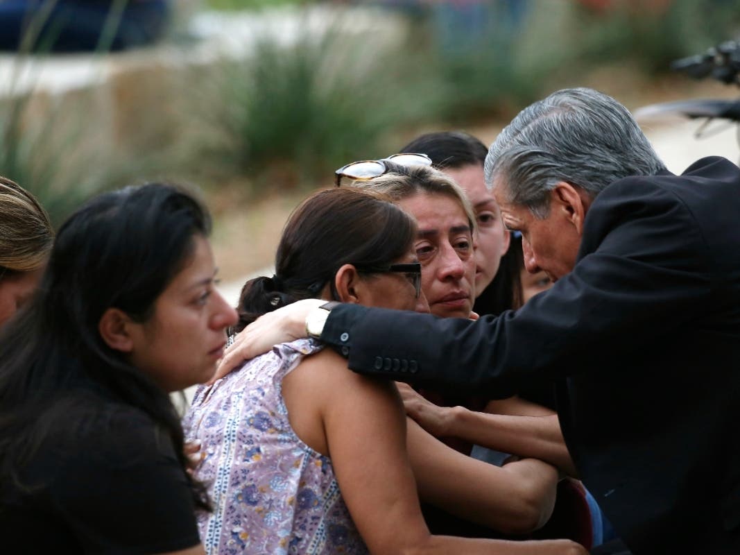 San Antonio Archbishop Gustavo Garcia-Siller comforts families after a deadly school shooting at Robb Elementary School in Uvalde, Texas.
