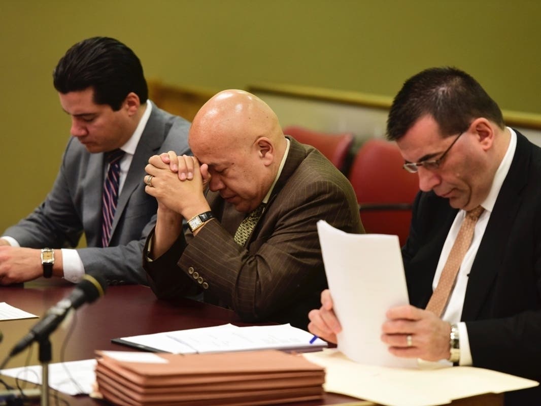 Former Paterson Mayor Jose "Joey" Torres lowers his head down before his sentencing begins Tuesday, Nov. 14, 2017, in Jersey City, N.J.