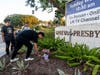Hector Gomez (left) and Jordi Poblete, worship leaders at the Mariners Church Irvine, leave flowers outside the Geneva Presbyterian Church in Laguna Woods on Sunday after a fatal shooting. 