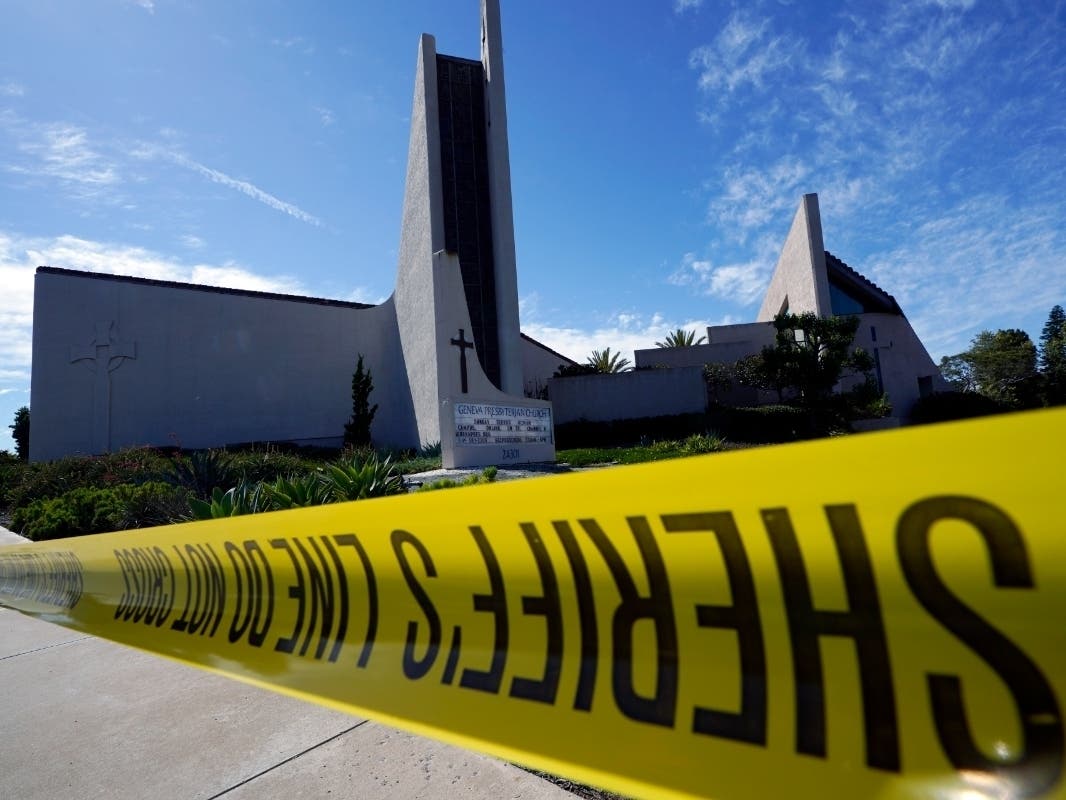 Crime scene tape is stretched across an area at Geneva Presbyterian Church in Laguna Woods on Sunday after a fatal shooting.