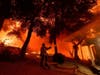 A firefighter battles the Airport Fire, Tuesday, Sept. 10, 2024, in El Cariso, an unincorporated community in Riverside County, Calif.