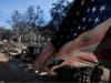 A partially burned flag is placed on a property in the aftermath off the Airport Fire Wednesday, Sept. 11, 2024, in El Cariso Village, in unincorporated Riverside. 