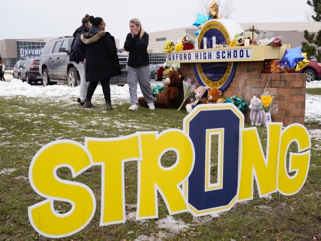 Students grieve at a memorial at Oxford High School in Oxford, Mich., Wednesday, Dec. 1, 2021. Authorities say a 15-year-old sophomore opened fire at Oxford High School, killing four students and wounding seven other people on Tuesday. 
