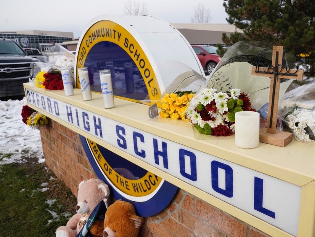 Memorial items are shown on the sign of Oxford High School in Oxford, Mich., Wednesday, Dec. 1, 2021. A 15-year-old sophomore opened fire at the school, killing several students and wounding multiple other people, including a teacher. 