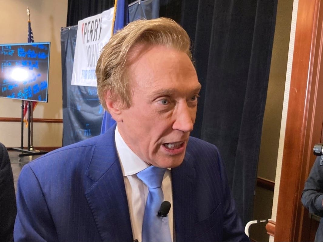 Michigan gubernatorial candidate Perry Johnson, a Republican, briefly speaks with reporters, on Feb. 23, 2022, after a kickoff event at a hotel in Lansing, Mich. Johnson lost a bid to get on the Aug. 2 primary ballot Wednesday.