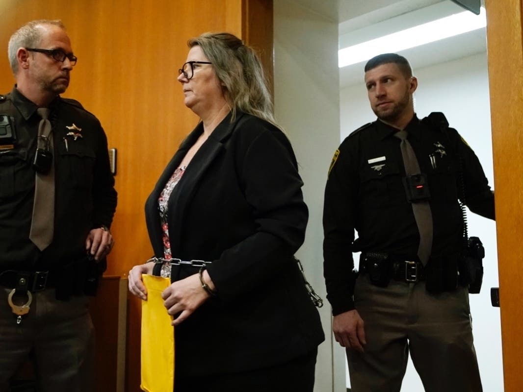 Jennifer (pictured, center) and her husband James Crumbley were each charged with four counts of involuntary manslaughter in connection with the deadly Oxford school shooting that left four dead on Nov. 30, 2021.