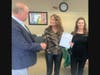 Mike Boyle, chairman of Bethel's Economic Development Commission, as he awards a grant to Karen (left) and Lisa Petri, of the Petri School of Irish Dancing, one of the businesses selected for a COVID grant. 