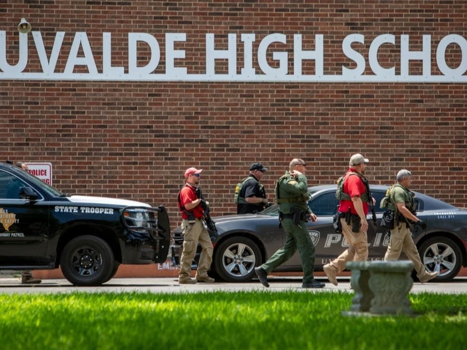 Law enforcement personnel walk outside Uvalde High School after shooting a was reported earlier in the day at Robb Elementary School, Tuesday, May 24, 2022, in Uvalde, Texas.