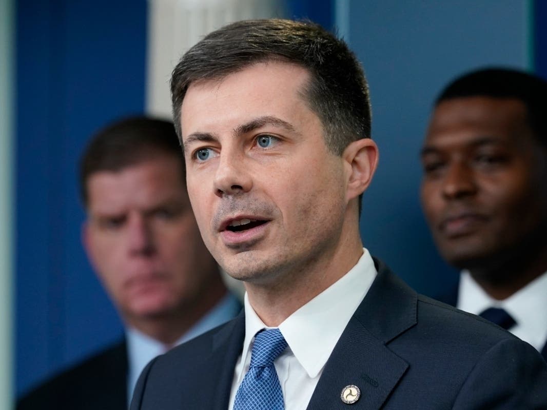 Transportation Secretary Pete Buttigieg, center, speaks during a briefing at the White House in Washington, Monday, May 16, 2022, on the six-month anniversary of the bipartisan infrastructure law. 