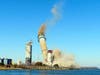 The smokestack at the former B.L. England power plant in Upper Township, N.J., is toppled during a control demolition, Thursday, Oct. 26, 2023. The site will be redeveloped as a mixed use residential and commercial project.
