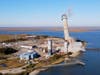 The smokestack at the former B.L. England power plant in Upper Township, N.J., is toppled during a control demolition, Thursday, Oct. 26, 2023. The site will be redeveloped as a mixed use residential and commercial project.