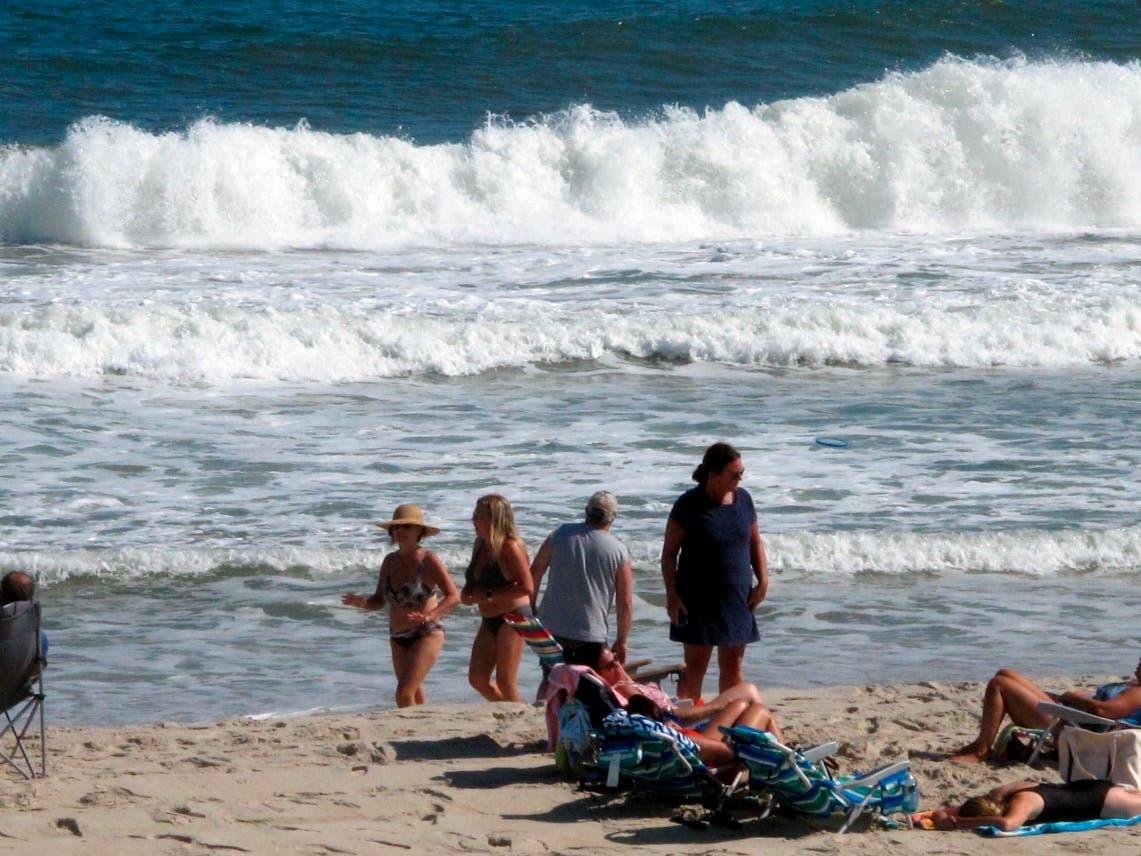 In this Sept. 18, 2021 photo, people enjoy the beach in Beach Haven, N.J. 