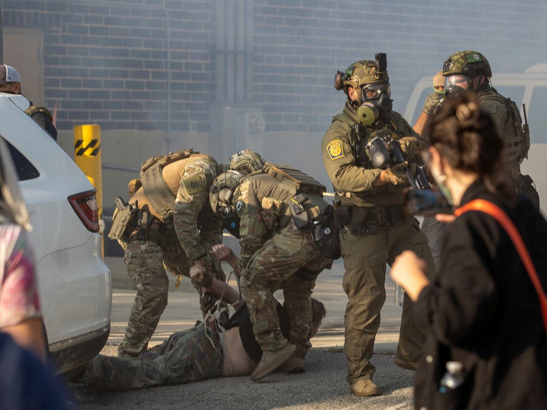 Immigration and Customs Enforcement officers arrest a protester at the ICE facility in Broadview, Ill., Sept. 19, 2025.