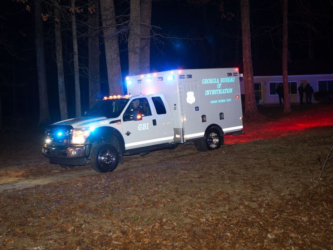 A GBI vehicle leaves a house Tuesday, Jan. 6, 2015, where a shooting happened. The GBI is looking into a Wednesday shooting, where authorities say Cobb County police shot and killed a man they say tried to attack them with a knife.