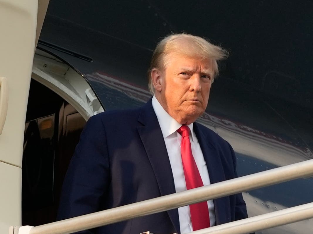 Former President Donald Trump steps off his plane as he arrives at Hartsfield-Jackson Atlanta International Airport, Thursday, Aug. 24, 2023, in Atlanta.