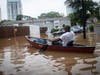 An unidentified man paddles a canoe to rescue residents and their belongings at a flooded apartment complex after Hurricane Helene passed the area on Friday, Sept. 27, 2024, in Atlanta.