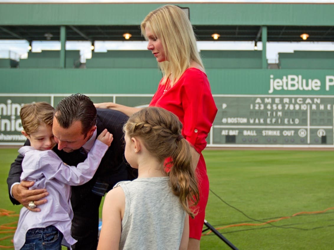 Boston Red Sox pitcher Tim Wakefield, center left, hugs his son, Trevor, 7, as his wife, Stacy, right, and daughter, Brianna, 6, look on after Wakefield announced his retirement from baseball during a news conference, Friday, Feb. 17, 2012, in Florida.