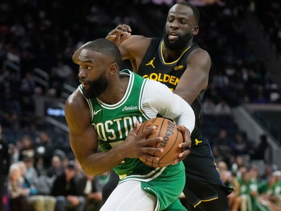 Boston Celtics guard Jaylen Brown, bottom, drives to the basket against Golden State Warriors forward Draymond Green during the second half of an NBA basketball game in San Francisco, Thursday, Feb. 19, 2026.