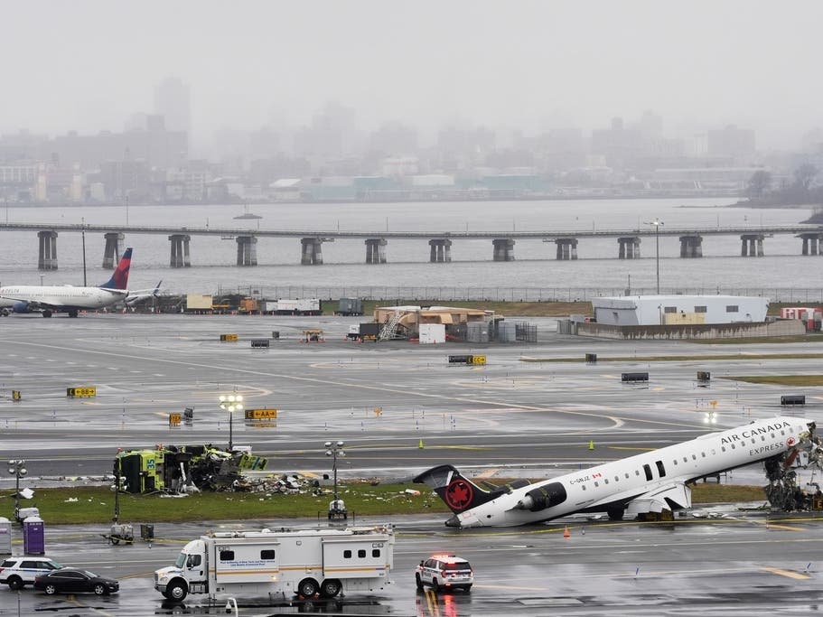 An Air Canada jet and Port Authority fire truck sit on the runway at LaGuardia Airport, Monday, March 23, 2026, after colliding with each other after the jet landed Sunday night in New York