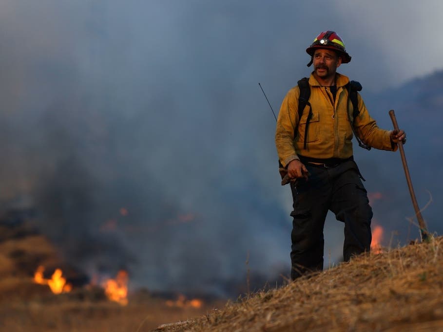 A firefighter conducts a firing operation to control Sandy Fire, Tuesday, May 19, 2026, in Simi Valley.