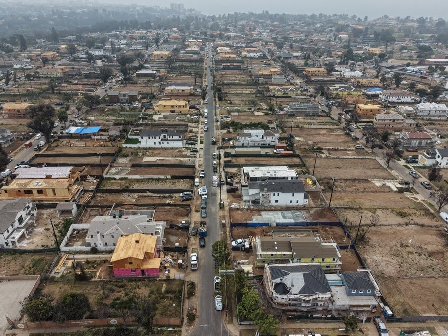 An aerial view from June 4 shows homes under construction amid empty lots more than a year after the Palisades Fire in Pacific Palisades.