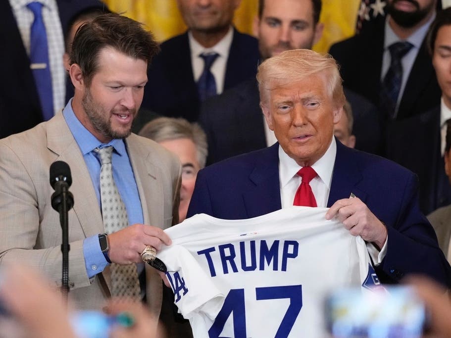 Los Angeles Dodgers' Clayton Kershaw presents a jersey to President Donald Trump, right, during a ceremony to honor the Major League Baseball 2024 World Series Champion team in the East Room of the White House, Monday, April 7, 2025, in Washington.