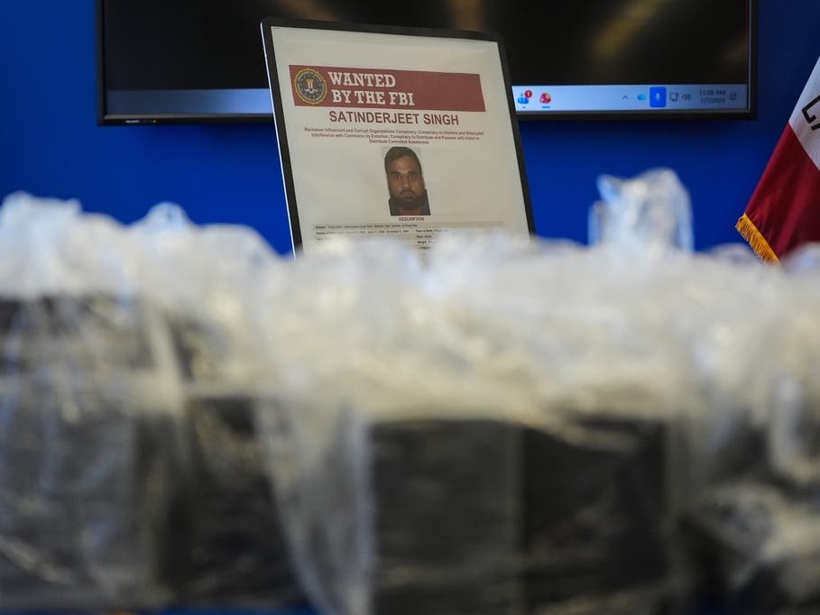 An FBI Wanted poster for Satinderjeet Singh is displayed at a news conference at the Federal Building in Los Angeles, Tuesday, July 7, 2026.