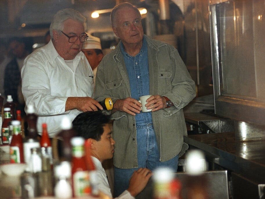 The Original Pantry Cafe was previously owned by the late former Los Angeles mayor Richard Riordan, right, pictured inside the restaurant in 1997 alongside general manager Duane Burrell.