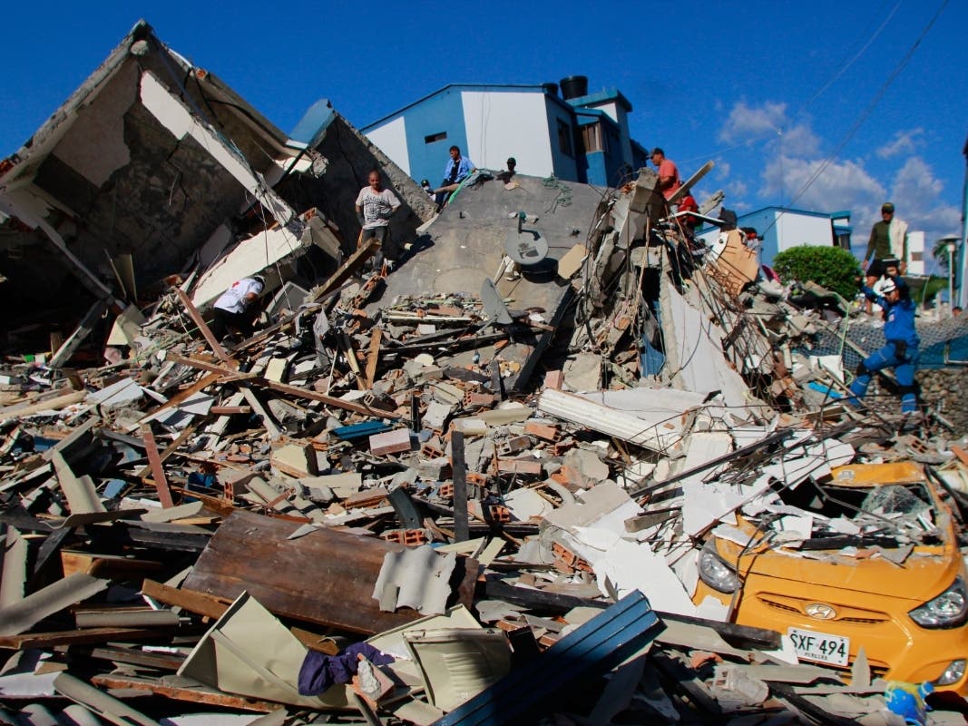 Residents search through the rubble after an earthquake struck Pereira, Colombia, Monday, Aug. 10, 2026.