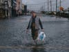 Bernard Dowd walks along a flooded street during a nor'easter storm on Sunday, Sept. 27, 2026, in Sea Bright, N.J.