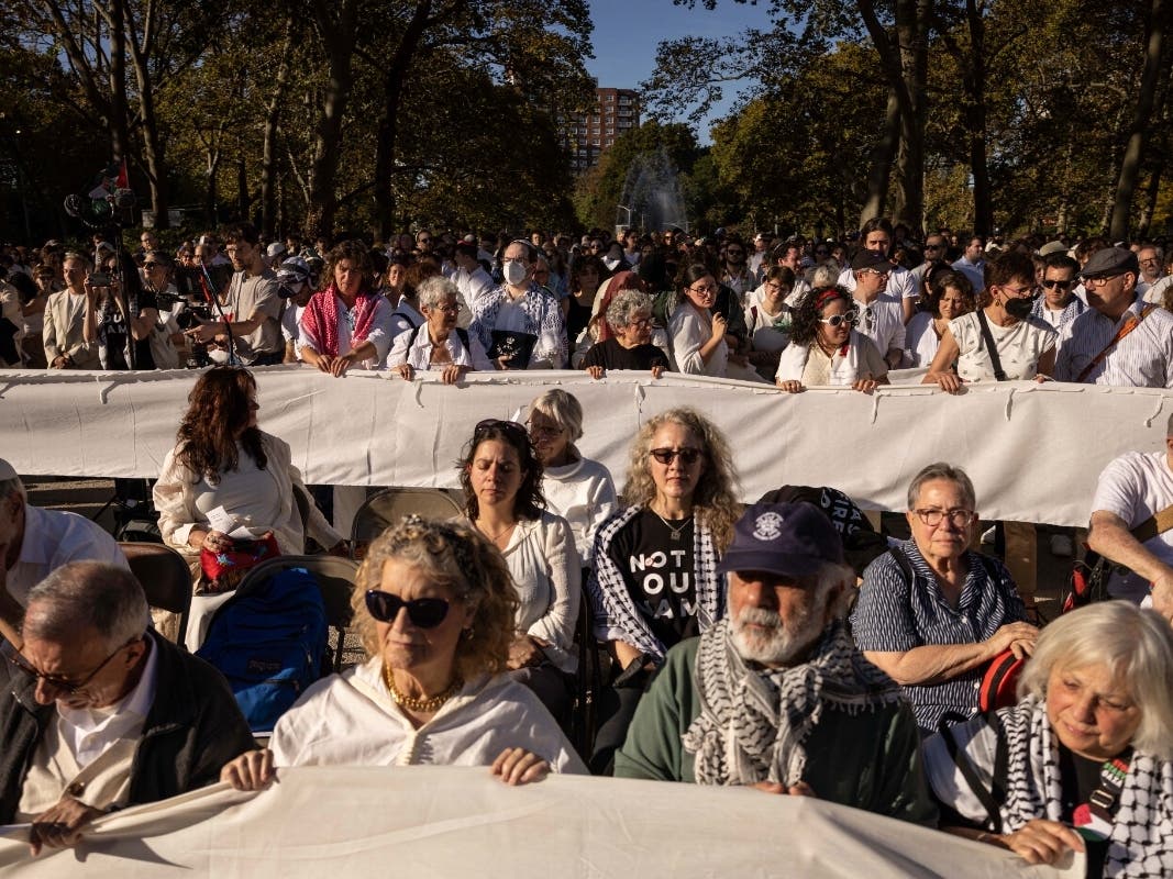 People hold banners during Yizkor, a Jewish prayer service for the dead, to demand a permanent cease-fire in Gaza, on Yom Kippur in the Brooklyn borough of New York, Saturday, Oct. 12, 2024.