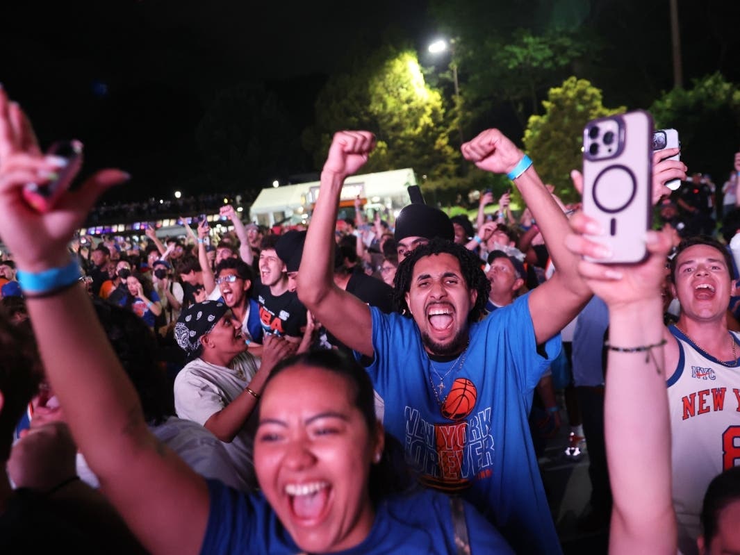 New York Knicks fans celebrate during a watch party inside Central Park during Game 4 of the NBA Finals basketball series between the Knicks and the San Antonio Spurs, Wednesday, June 10, 2026, in New York.