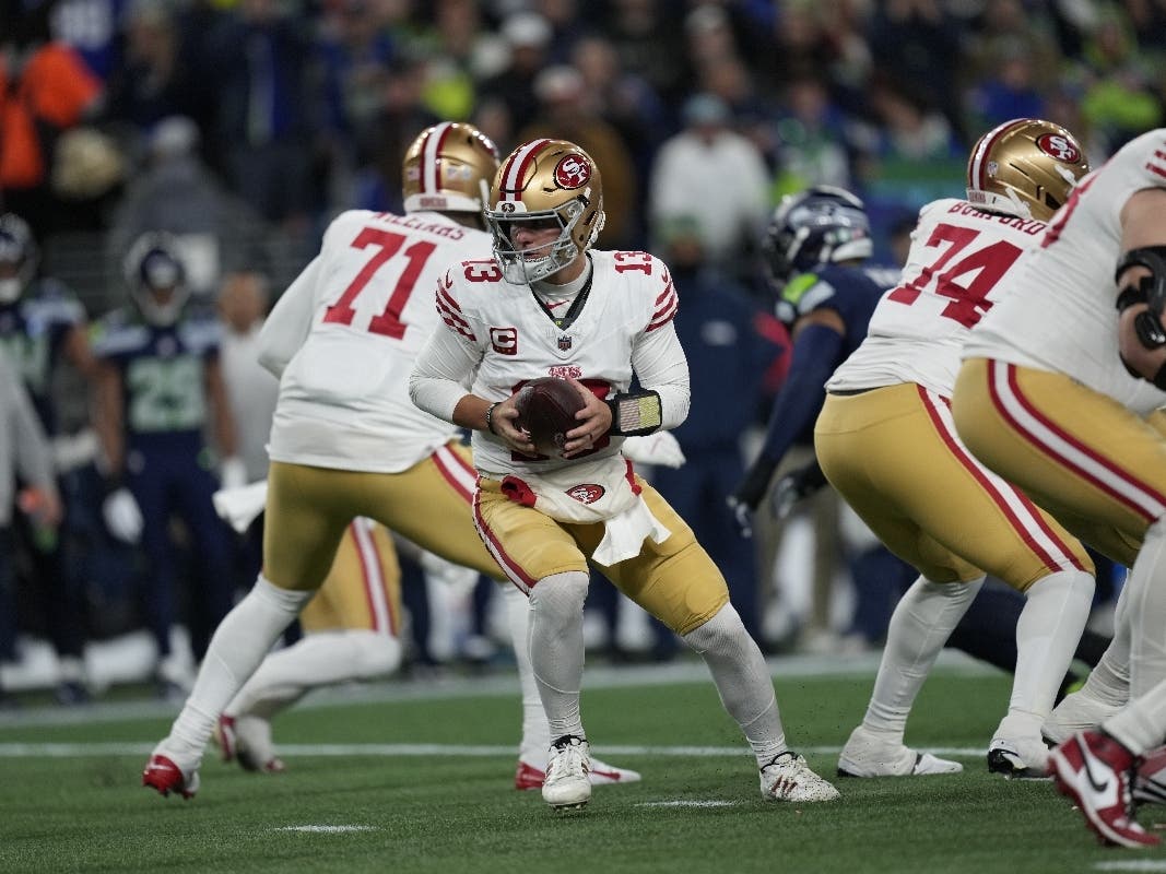 San Francisco 49ers quarterback Brock Purdy (13) looks to hand off the ball in an NFL divisional playoff football game, Saturday, Jan. 17, 2026, in Seattle.