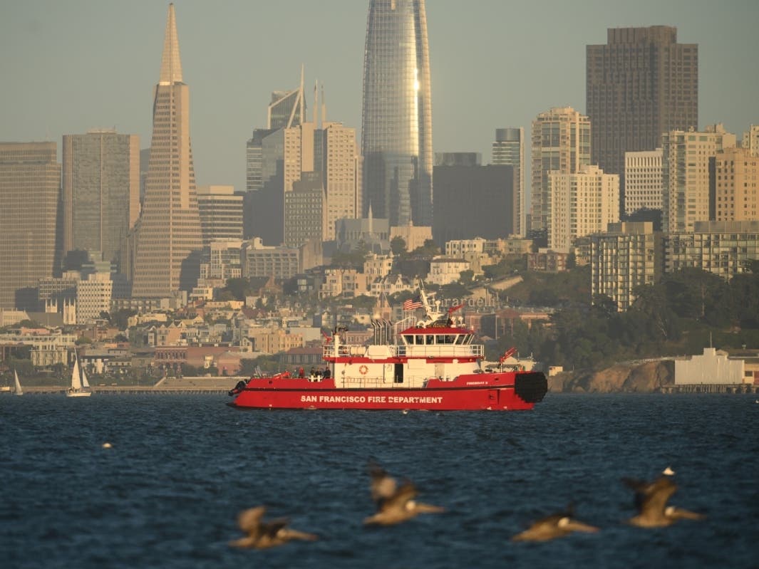A San Francisco Fire Department vessel passes in front of ot the city skyline while searching for missing victims after a boat accident near Alcatraz Island off San Francisco on Tuesday, July 14, 2026