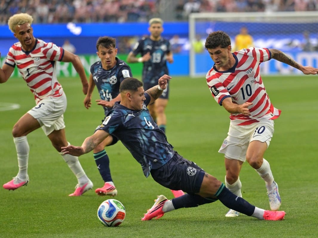 United States' Christian Pulisic (10) is challenged by Paraguay's Juan Jose Caceres (4) during the World Cup Group D soccer match between the United States and Paraguay in Inglewood, Calif., near Los Angeles, Friday, June 12, 2026.